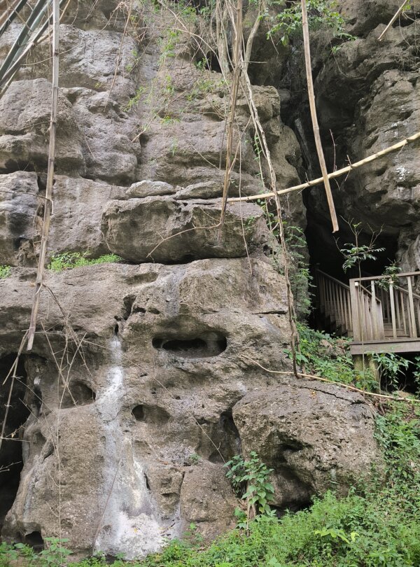 Inside view of Gua Batu Cermin with light beams reflecting off the cave walls