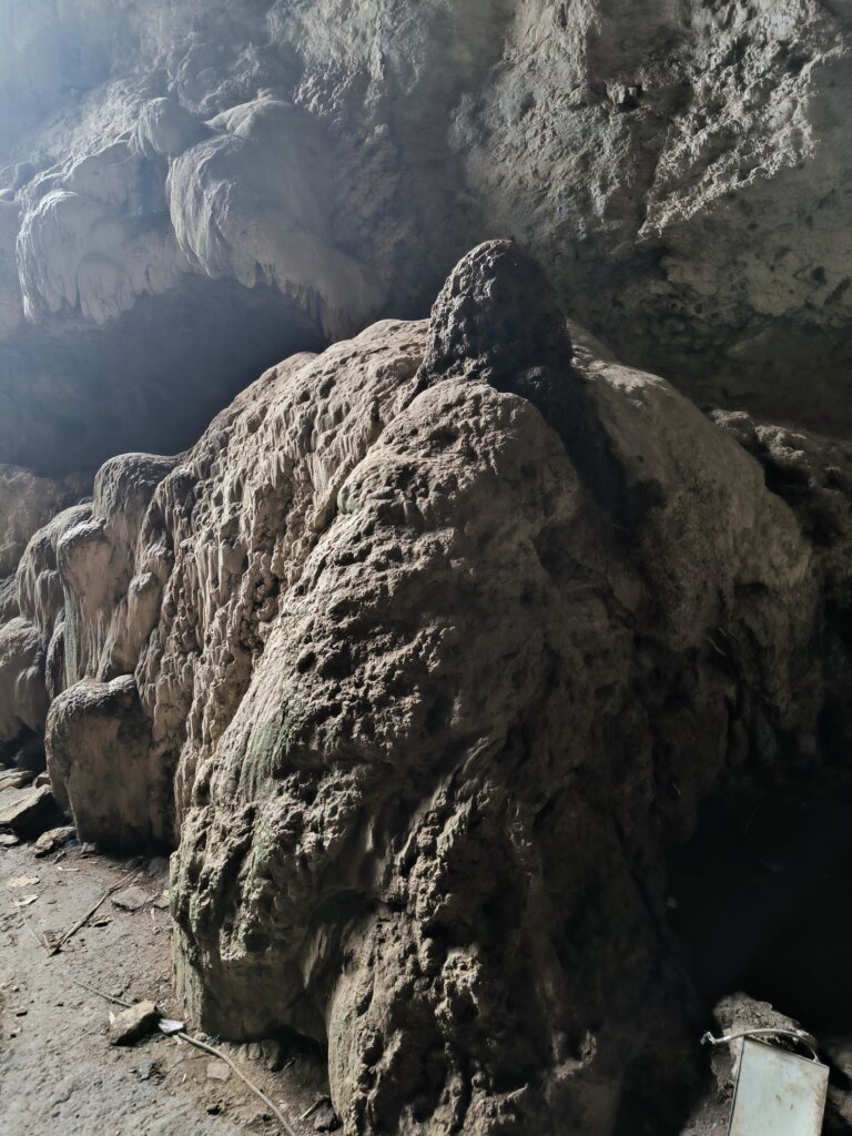 Inside view of Gua Batu Cermin with light beams reflecting off the cave walls
