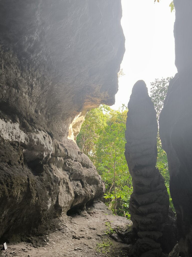 Inside view of Gua Batu Cermin with light beams reflecting off the cave walls