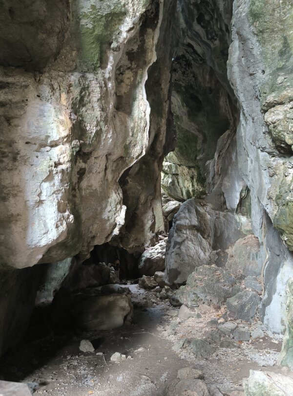 Inside view of Gua Batu Cermin with light beams reflecting off the cave walls
