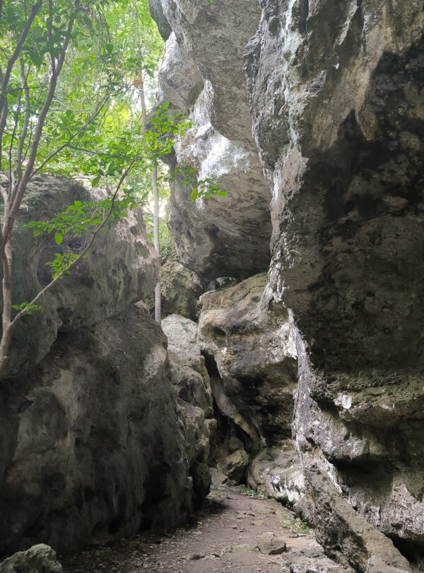 Inside view of Gua Batu Cermin with light beams reflecting off the cave walls