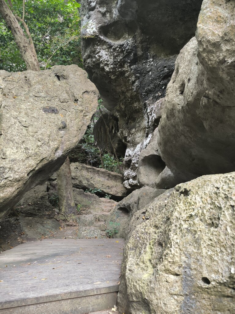 Inside view of Gua Batu Cermin with light beams reflecting off the cave walls