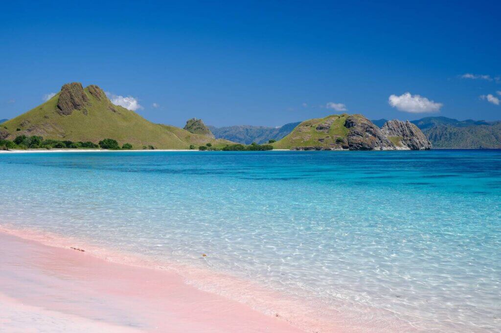 Soft pink sand and clear turquoise waters at Pink Beach in Komodo National Park, Indonesia