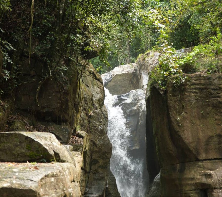 Cunca Wulang – Hidden Canyon and Waterfall in Flores Emerald green river flowing between steep canyon walls at Cunca Wulang Waterfall in Flores