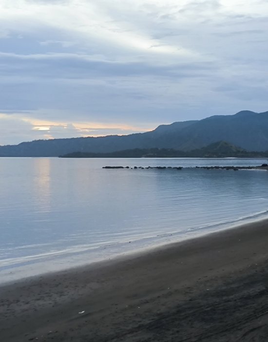 Golo Mori – The Scenic Coastal Gem of Flores Panoramic view of Golo Mori’s coastline with turquoise waters and rolling green hills in Flores, Indonesia